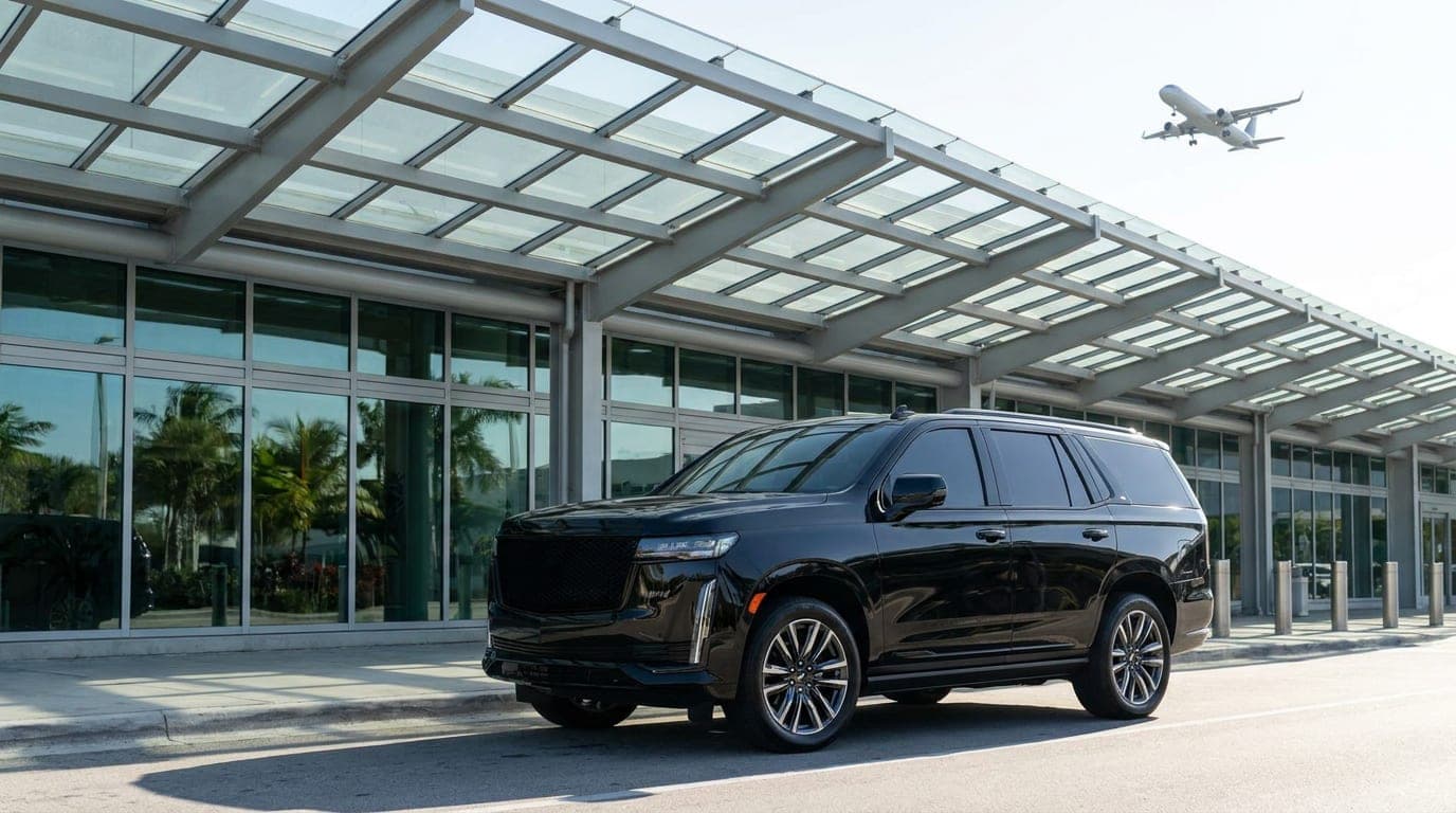 Black Escalade ESV at the arrivals curb of Miami International Airport