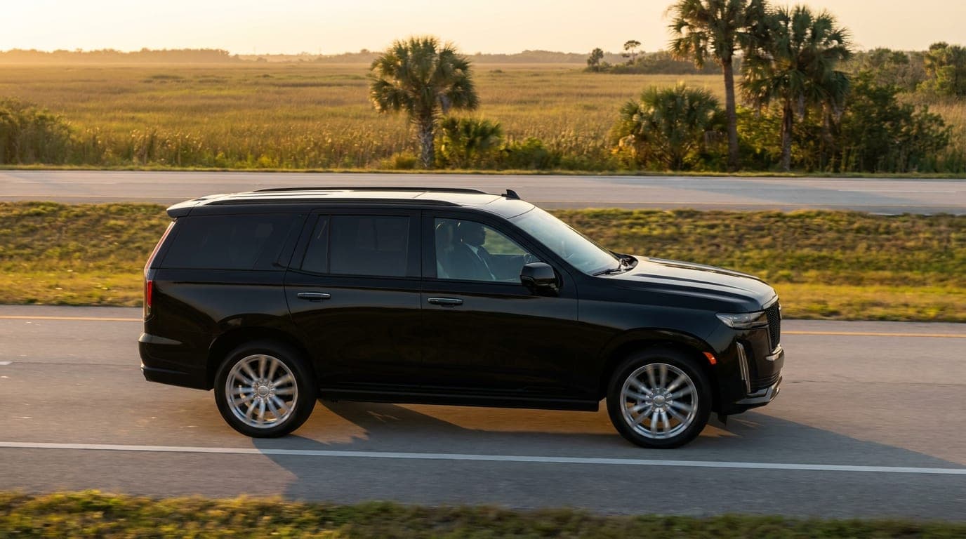 Black SUV driving north on the Florida Turnpike at sunset, private transfer from Miami to Orlando